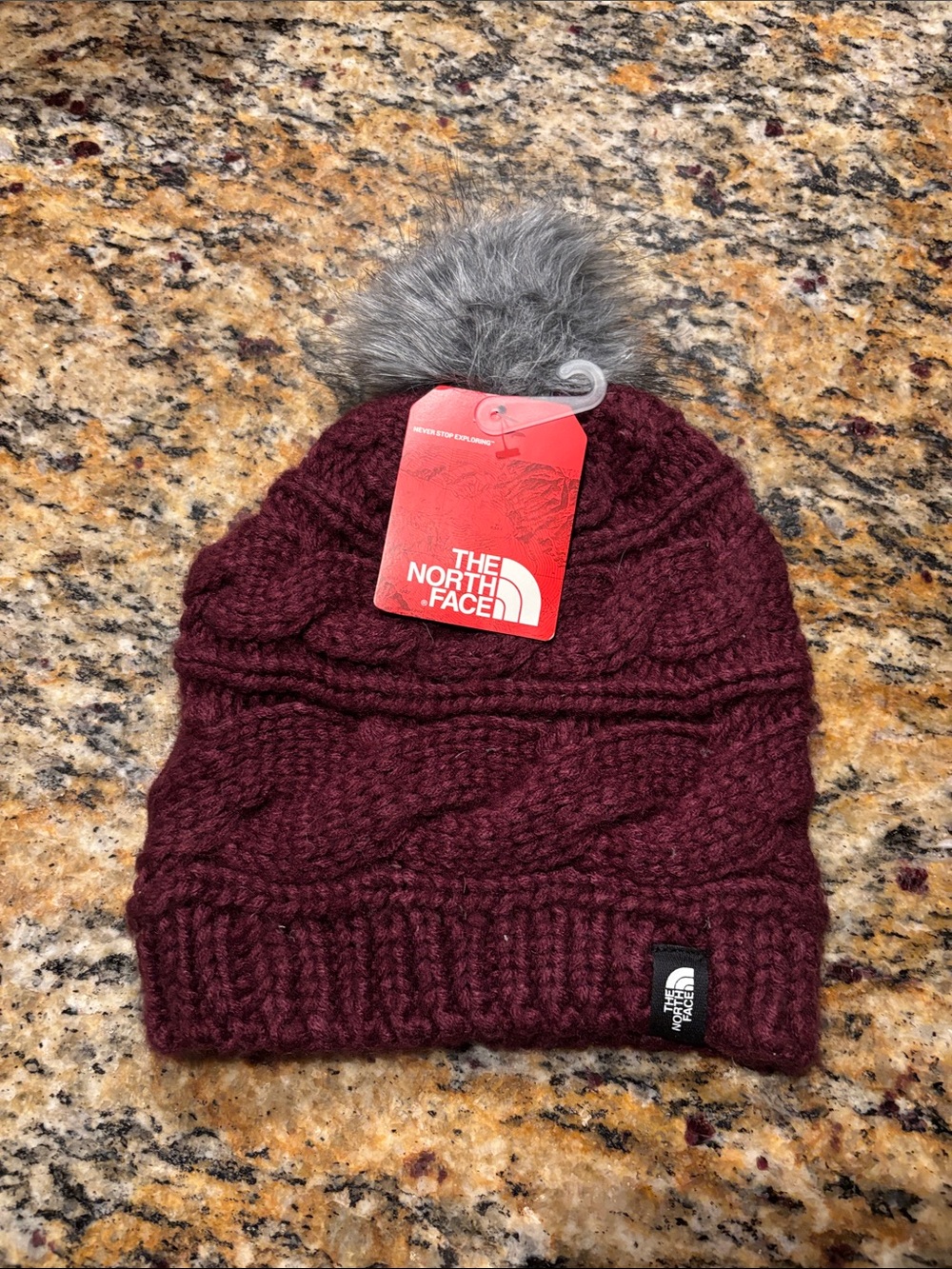 The North Face Burgundy Cable-Knit Beanie with Gray Pom